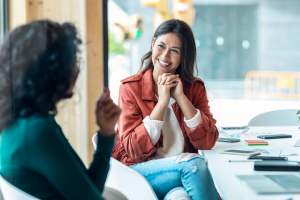 Woman talking and smiling with another woman