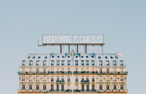 building with "everything is canceled" billboard