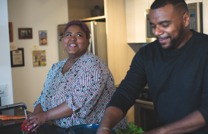 man and woman standing in kitchen