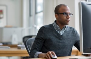 Businessman working on desktop computer in office