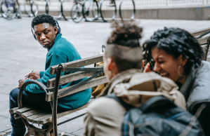 students-gossiping-and-laughing-near-black-man