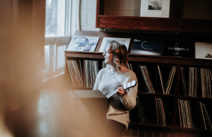 woman-playing-guitar-near-window