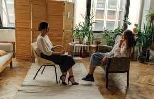 two women in white shirts sitting in chairs