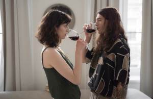Couple drinking glasses of wine while looking at each other