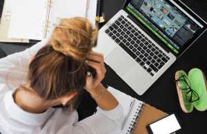 Woman with bun staring at a laptop