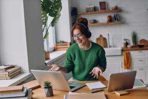 Woman using multiple computers at a desk