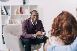 Psychiatrist talking to young couple in his office