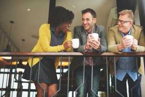 Three people chatting with coffee