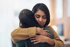 Two women hugging