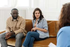 Man and a woman talking to a therapist