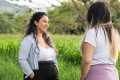 Two women talking in a field of tall grass