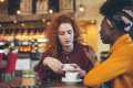 Two women talking at a coffee shop